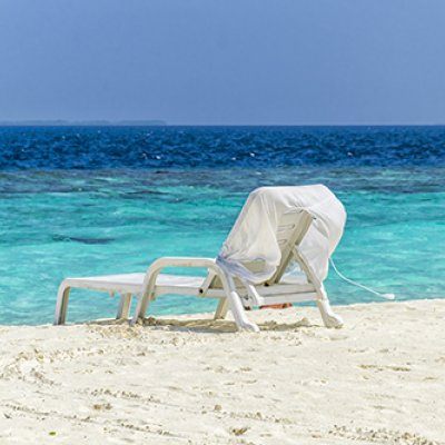 Empty beach chair sitting on a beautiful Queensland beach 